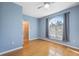 Neutral bedroom with hardwood floors and large arched window, providing ample natural light at 1623 Crossvine Ct, New Port Richey, FL 34655