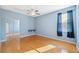 Empty bedroom featuring hardwood floors, closet with mirrored doors and fan with overhead lighting at 1623 Crossvine Ct, New Port Richey, FL 34655