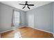 Neutral bedroom with hardwood floors and a window, providing ample natural light at 1623 Crossvine Ct, New Port Richey, FL 34655