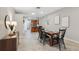 Dining room features wood table and views of the kitchen and home entry at 1623 Crossvine Ct, New Port Richey, FL 34655