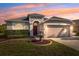 Charming single-story home showcasing a well-manicured lawn and a decorative front yard fountain at 1623 Crossvine Ct, New Port Richey, FL 34655