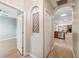 Inviting hallway featuring arched doorways and tile flooring with a glimpse into the dining area at 1623 Crossvine Ct, New Port Richey, FL 34655