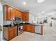 Well-lit kitchen features wood cabinetry, granite countertops, and stainless steel appliances at 1623 Crossvine Ct, New Port Richey, FL 34655