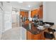 Open-concept kitchen showcasing wood cabinets, granite counters and a breakfast bar at 1623 Crossvine Ct, New Port Richey, FL 34655