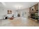 Inviting living room features a stone fireplace, neutral walls, and access to the outdoor space at 1623 Crossvine Ct, New Port Richey, FL 34655