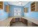 Bright, blue-walled office space with built-in desks, cabinetry, and natural light at 1623 Crossvine Ct, New Port Richey, FL 34655