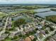 Expansive community aerial view featuring many homes surrounding lakes and nature preserves at 17905 Machair Ln, Land O Lakes, FL 34638