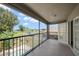Balcony view featuring a screened enclosure, overlooking a pool and lake at 17905 Machair Ln, Land O Lakes, FL 34638