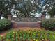 Elegant community entrance sign with stone accents and colorful flower beds at 17905 Machair Ln, Land O Lakes, FL 34638