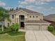 Exterior aerial view of a two-story home featuring a three-car garage and a landscaped front yard at 17905 Machair Ln, Land O Lakes, FL 34638