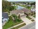 An aerial view of a two-story home with a three-car garage, landscaped yard, and beautiful curb appeal at 17905 Machair Ln, Land O Lakes, FL 34638