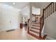 Bright and spacious foyer with a staircase, tile flooring, and a view into the living room at 17905 Machair Ln, Land O Lakes, FL 34638