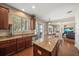 Well-lit kitchen with stainless steel appliances, granite countertops, and breakfast bar seating at 17905 Machair Ln, Land O Lakes, FL 34638