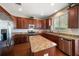 Spacious kitchen featuring wood cabinets, granite countertops, and stainless steel appliances at 17905 Machair Ln, Land O Lakes, FL 34638