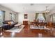 Elegant living room featuring hardwood floors, classic furnishings, and ample natural light at 17905 Machair Ln, Land O Lakes, FL 34638