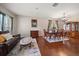 Elegant living room featuring hardwood floors, classic furnishings, and ample natural light at 17905 Machair Ln, Land O Lakes, FL 34638