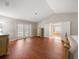 The large main bedroom features wood floors and en suite bath with dual sinks, a jetted tub, and a separate shower at 17905 Machair Ln, Land O Lakes, FL 34638
