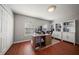 Well-lit home office with wood floors, built-in bookshelves, and a large desk at 17905 Machair Ln, Land O Lakes, FL 34638