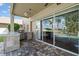 Outdoor kitchen with a grill and bar overlooking the pool and lush backyard at 17905 Machair Ln, Land O Lakes, FL 34638