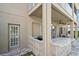 Covered outdoor kitchen area with granite countertops, built-in grill, and outdoor seating at 17905 Machair Ln, Land O Lakes, FL 34638