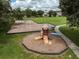 Aerial view of the neighborhood playground with swings, slide and benches at 17905 Machair Ln, Land O Lakes, FL 34638