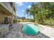 Backyard oasis with a sparkling pool, waterfall feature, lush landscaping, and a covered lanai at 17905 Machair Ln, Land O Lakes, FL 34638