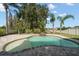 Private pool area featuring a waterfall, lush tropical landscaping, and a pristine white fence at 17905 Machair Ln, Land O Lakes, FL 34638