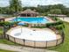 Aerial view of a community pool area featuring a pool, kiddie splash area, and lounge seating at 17905 Machair Ln, Land O Lakes, FL 34638