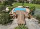 Aerial view of the community pool, clubhouse, tennis courts, and playground at 17905 Machair Ln, Land O Lakes, FL 34638
