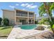 Backyard view showcasing a private pool, screened lanai, and a stone bar perfect for outdoor entertainment at 17905 Machair Ln, Land O Lakes, FL 34638