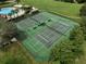 Aerial view of the community tennis courts with benches and shade at 17905 Machair Ln, Land O Lakes, FL 34638