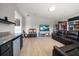 Home theater with a mini bar, large screen tv, sectional sofa, and bookshelves at 17905 Machair Ln, Land O Lakes, FL 34638