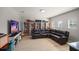 Cozy theater room featuring a large sectional couch and built in bookshelves at 17905 Machair Ln, Land O Lakes, FL 34638
