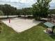 Aerial view of a sand volleyball court near a covered picnic table and playground at 17905 Machair Ln, Land O Lakes, FL 34638
