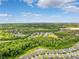 Aerial view of the community surrounded by lush landscaping and a pond at 18566 Hunters Meadow Walk, Land O Lakes, FL 34638