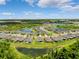 Aerial view of the community, featuring ponds and lush landscaping at 18566 Hunters Meadow Walk, Land O Lakes, FL 34638