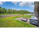 Landscaped backyard with a fire pit area and a well-maintained lawn at 18566 Hunters Meadow Walk, Land O Lakes, FL 34638