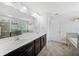 Bright bathroom with double sink vanity, large mirror, walk-in shower, and soaking tub at 18566 Hunters Meadow Walk, Land O Lakes, FL 34638