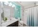 The bathroom includes a vanity with a sink, a toilet, and a shower with a white curtain at 18566 Hunters Meadow Walk, Land O Lakes, FL 34638