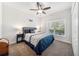 Comfortable bedroom featuring soft carpet flooring, natural light, and dark wood furniture at 18566 Hunters Meadow Walk, Land O Lakes, FL 34638