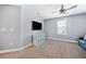 Neutral bedroom with ceiling fan, TV, and lots of natural light at 18566 Hunters Meadow Walk, Land O Lakes, FL 34638