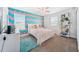 Cheery bedroom with light pink and aqua chevron accent wall, carpet flooring and natural light at 18566 Hunters Meadow Walk, Land O Lakes, FL 34638
