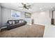 Upper bonus room with neutral carpet and blue accent wall and mountain painting at 18566 Hunters Meadow Walk, Land O Lakes, FL 34638