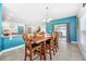 Open dining room with sliding doors, pendant lighting, and access to kitchen at 18566 Hunters Meadow Walk, Land O Lakes, FL 34638