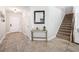 Foyer area featuring tile floors, staircase, and hall table with decor at 18566 Hunters Meadow Walk, Land O Lakes, FL 34638