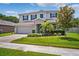 Charming two-story home with manicured landscaping, a well-maintained lawn, and a welcoming two-car garage at 18566 Hunters Meadow Walk, Land O Lakes, FL 34638