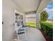 Charming front porch with rocking chairs and decorative plants at 18566 Hunters Meadow Walk, Land O Lakes, FL 34638