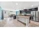 Open kitchen with granite countertops, stainless steel appliances, and large island at 18566 Hunters Meadow Walk, Land O Lakes, FL 34638