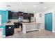 Modern kitchen featuring dark cabinetry, granite countertops, and stainless steel appliances at 18566 Hunters Meadow Walk, Land O Lakes, FL 34638
