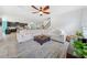 Bright living room boasts a large sectional couch, decorative rug, and views of the kitchen at 18566 Hunters Meadow Walk, Land O Lakes, FL 34638